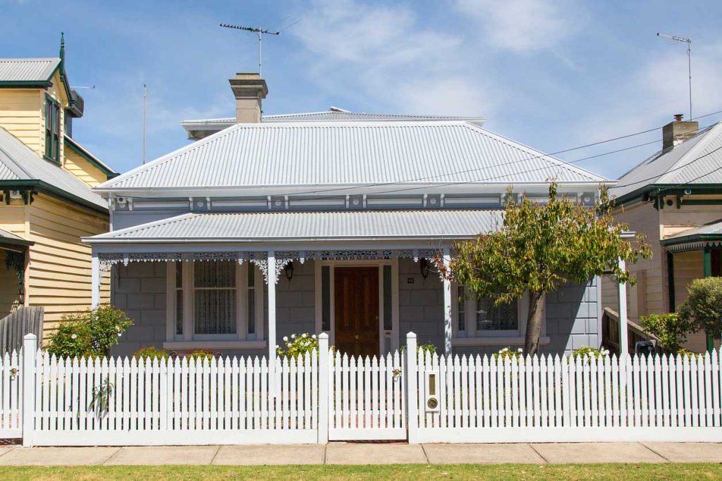 Heritage house with white picket fence and verandah