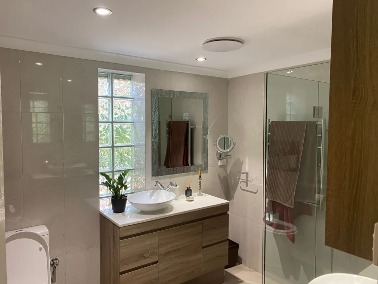 Modern bathroom with timber vanity and glass shower