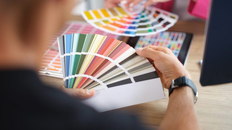 Person holding colour swatches choosing paint samples