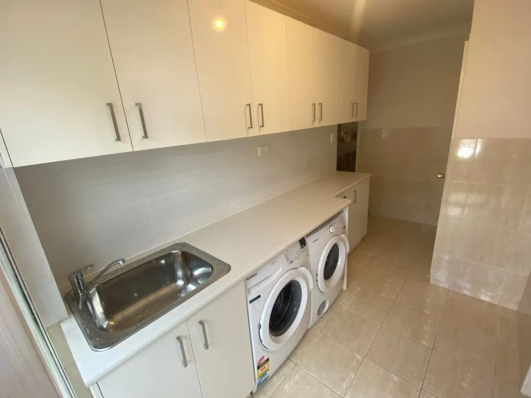 Modern laundry room with washer, dryer and sink