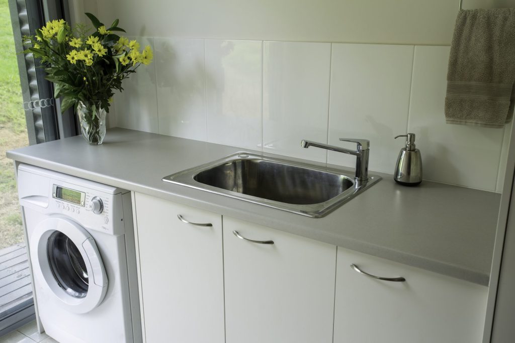 Modern laundry with sink and washing machine